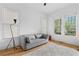 Sitting room with large windows, hardwood floors, a comfortable couch and stylish rug at 1054 Euclid Ne Ave, Atlanta, GA 30307