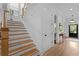 Staircase featuring hardwood steps, white risers and trim, and a view to the entry foyer at 1054 Euclid Ne Ave, Atlanta, GA 30307