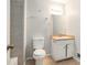 This bathroom features a toilet, sink, mirror, and shower with tile surround at 1512 Daniel Ln, Lawrenceville, GA 30046