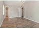Serene bedroom with wood-look floors, neutral walls, and convenient closet and bathroom access at 1512 Daniel Ln, Lawrenceville, GA 30046