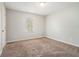 Comfortable bedroom with a neutral color scheme, plush carpeting, and a bright window at 1512 Daniel Ln, Lawrenceville, GA 30046