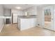 Open kitchen featuring white cabinetry, tiled floors, and a convenient breakfast bar at 1512 Daniel Ln, Lawrenceville, GA 30046