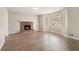Bright living room featuring a brick fireplace, large windows, and stylish wood-look flooring at 1512 Daniel Ln, Lawrenceville, GA 30046