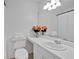 This bathroom is bright with new vanity and decorative flowers and towels at 3075 Camden Way, Alpharetta, GA 30005