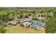 Aerial view of neighborhood pool, tennis courts, playground, and clubhouse amidst mature trees at 4783 Deer Chase, Powder Springs, GA 30127