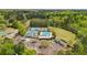 Aerial view featuring community tennis courts, playground, pool and clubhouse surrounded by lush trees at 4783 Deer Chase, Powder Springs, GA 30127