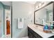 Neutral bathroom with vanity, mirror, modern lighting, and a light blue wall color at 4783 Deer Chase, Powder Springs, GA 30127