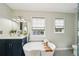 Bright bathroom boasts sink vanity, soaking tub, and glass enclosed shower with natural light at 4783 Deer Chase, Powder Springs, GA 30127