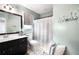 Traditional bathroom with vanity, toilet, shower-tub, and black-and-white tiled floor at 4783 Deer Chase, Powder Springs, GA 30127