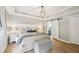 Bright bedroom boasts wood floors, stylish light fixture, and ensuite bathroom access via sliding barn door at 4783 Deer Chase, Powder Springs, GA 30127