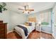 Bedroom with hardwood floors, modern lighting, ceiling fan, and a vintage dresser at 4783 Deer Chase, Powder Springs, GA 30127