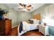 Comfortable bedroom with hardwood floors, vintage dresser, a ceiling fan, and natural lighting at 4783 Deer Chase, Powder Springs, GA 30127