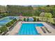 Community swimming pool surrounded by greenery and tennis courts, offering ample recreational space at 4783 Deer Chase, Powder Springs, GA 30127