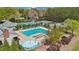 An aerial view of a large pool with ample seating surrounded by lush greenery and tennis courts at 4783 Deer Chase, Powder Springs, GA 30127