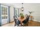 Elegant dining room featuring a dark wood table with black chairs, hardwood floors, and ample natural light at 4783 Deer Chase, Powder Springs, GA 30127