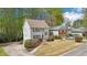 View of a two-story home with charming details, a well-kept lawn, and mature trees on a sunny day at 4783 Deer Chase, Powder Springs, GA 30127