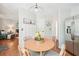 Bright eat-in kitchen area showcasing a round table, stainless steel appliances, and a view into the living room at 4783 Deer Chase, Powder Springs, GA 30127