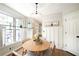 Eat-in kitchen area filled with natural light, showcasing a round table and chairs, along with white cabinetry at 4783 Deer Chase, Powder Springs, GA 30127