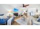 Inviting living area with a stone fireplace, ceiling fan, hardwood floors, and comfortable seating arrangement at 4783 Deer Chase, Powder Springs, GA 30127