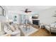 Bright and cozy living room features a stone fireplace, hardwood floors, and comfortable neutral furniture at 4783 Deer Chase, Powder Springs, GA 30127