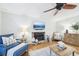 Cozy living room featuring a stone fireplace, hardwood floors, and comfortable blue and neutral furniture at 4783 Deer Chase, Powder Springs, GA 30127