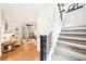 Inviting living room with hardwood floors flowing into stairway featuring carpeted steps and railing at 4783 Deer Chase, Powder Springs, GA 30127