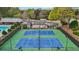 Aerial shot of two well-maintained tennis courts adjacent to community buildings at 4783 Deer Chase, Powder Springs, GA 30127