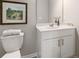 Bright and neat powder room with a vessel sink, vanity, framed art, and essential fixtures at 5607 Hislop Ln # 80, Mableton, GA 30126