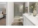 Modern bathroom with white vanity, glass shower, tile flooring, and neutral decor at 5607 Hislop Ln # 80, Mableton, GA 30126