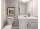Bright and neat powder room with a vessel sink, vanity, framed art, and essential fixtures at 5607 Hislop Ln # 80, Mableton, GA 30126