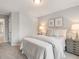 Relaxing bedroom featuring a plush queen bed, side tables, and a doorway to another room at 5607 Hislop Ln # 80, Mableton, GA 30126