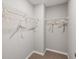 Walk-in closet featuring white wire shelving, carpeted floor, and neutral paint at 5607 Hislop Ln # 80, Mableton, GA 30126