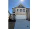 Charming two-story home with brick and siding, showcasing a well-manicured front yard and attached garage at 5607 Hislop Ln # 80, Mableton, GA 30126