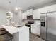 Bright kitchen featuring stainless steel appliances, white cabinetry and an island with bar stool seating at 5607 Hislop Ln # 80, Mableton, GA 30126