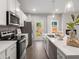 Bright kitchen boasts stainless appliances, white cabinetry and center island, seamlessly blending style and functionality at 5607 Hislop Ln # 80, Mableton, GA 30126