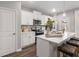 Well-lit kitchen featuring stainless appliances, white cabinets, and center island with bar stool seating at 5607 Hislop Ln # 80, Mableton, GA 30126