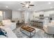 Open-concept living space with a kitchen featuring white cabinets and bar stool seating at 5607 Hislop Ln # 80, Mableton, GA 30126