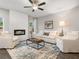 Bright living room featuring a fireplace, ceiling fan, and neutral-toned furniture at 5607 Hislop Ln # 80, Mableton, GA 30126