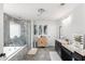 Bathroom with grey tile, dual sink vanity, and walk-in glass shower at 3478 Crayton Glen Way, Buford, GA 30519