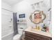 The bathroom features a vanity with a dark wood cabinet, a sink, a toilet, and a tub at 3478 Crayton Glen Way, Buford, GA 30519