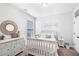 The charming bedroom features neutral decor, a white dresser, and ample natural light at 3478 Crayton Glen Way, Buford, GA 30519