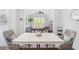 The dining room features hardwood floors, a white table, and wicker chairs at 3478 Crayton Glen Way, Buford, GA 30519