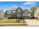 Attractive two-story home with stone accents, attached garage, and well-manicured front lawn at 3478 Crayton Glen Way, Buford, GA 30519