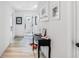 Bright hallway featuring neutral walls, a dark console table, and light wood-look floors at 3478 Crayton Glen Way, Buford, GA 30519