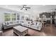 Bright and spacious living room with large sectional sofa and connection to kitchen at 3478 Crayton Glen Way, Buford, GA 30519