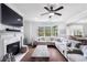 Comfortable living room with fireplace, large sectional, and views of backyard at 3478 Crayton Glen Way, Buford, GA 30519