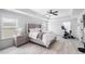 Bright bedroom featuring neutral tones, tray ceilings, and modern furniture, flooded with natural light at 3478 Crayton Glen Way, Buford, GA 30519