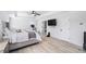 Open bedroom featuring a king bed, en-suite bathroom, and large windows with wood-look floors at 3478 Crayton Glen Way, Buford, GA 30519