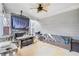 Cozy covered patio with a stone fireplace, seating area, and outdoor TV for relaxing or entertaining at 3478 Crayton Glen Way, Buford, GA 30519