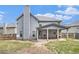 View of backyard with covered patio of home with blue siding and gray shingles at 415 Damascus Ct, Fairburn, GA 30213